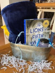 Corporate basket with blanket, candle and Lions of Fifth Ave Book in metal bucket