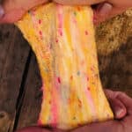 Cake Slime being stretched that looks like cake batter with sprinkles